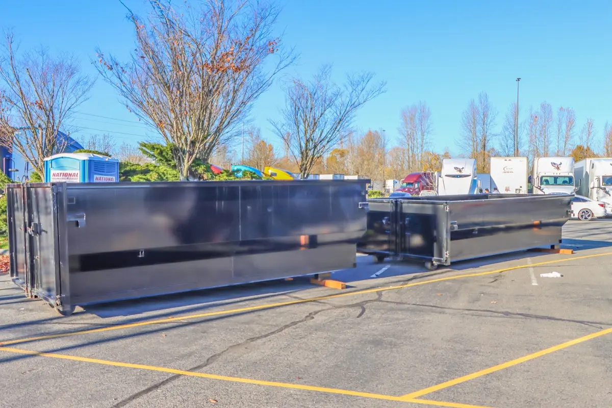 Professional dumpster rental service with roll-off container on residential driveway in Gulf Park Estates
